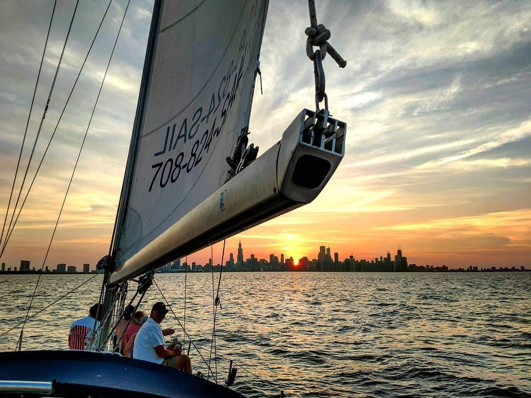 Chicago at sunset from sailboat during private sailing charter
